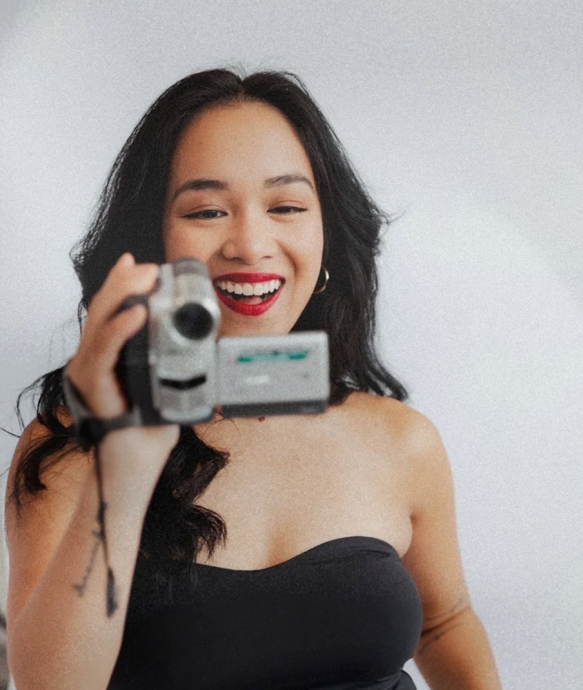 Allyjana holding a camcorder, laughing