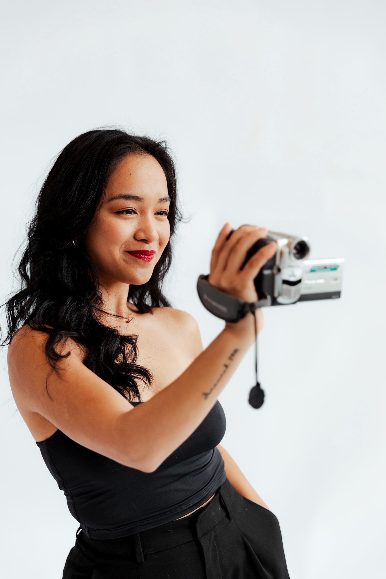 Allyjana filming with a handheld camcorder